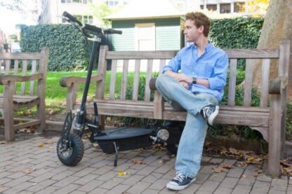 A man sitting on a bench with the Blaze 1000-watt 36v LITHIUM Electric Scooter
